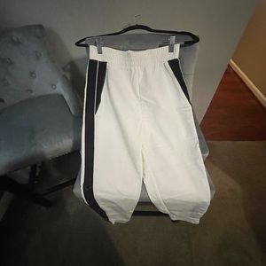 Brand new white snap button side track pant that can be dressed up or down.